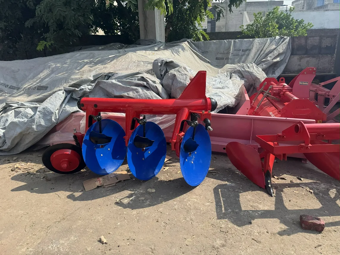 Red disc plough with blue concave discs, photographed in a machinery yard