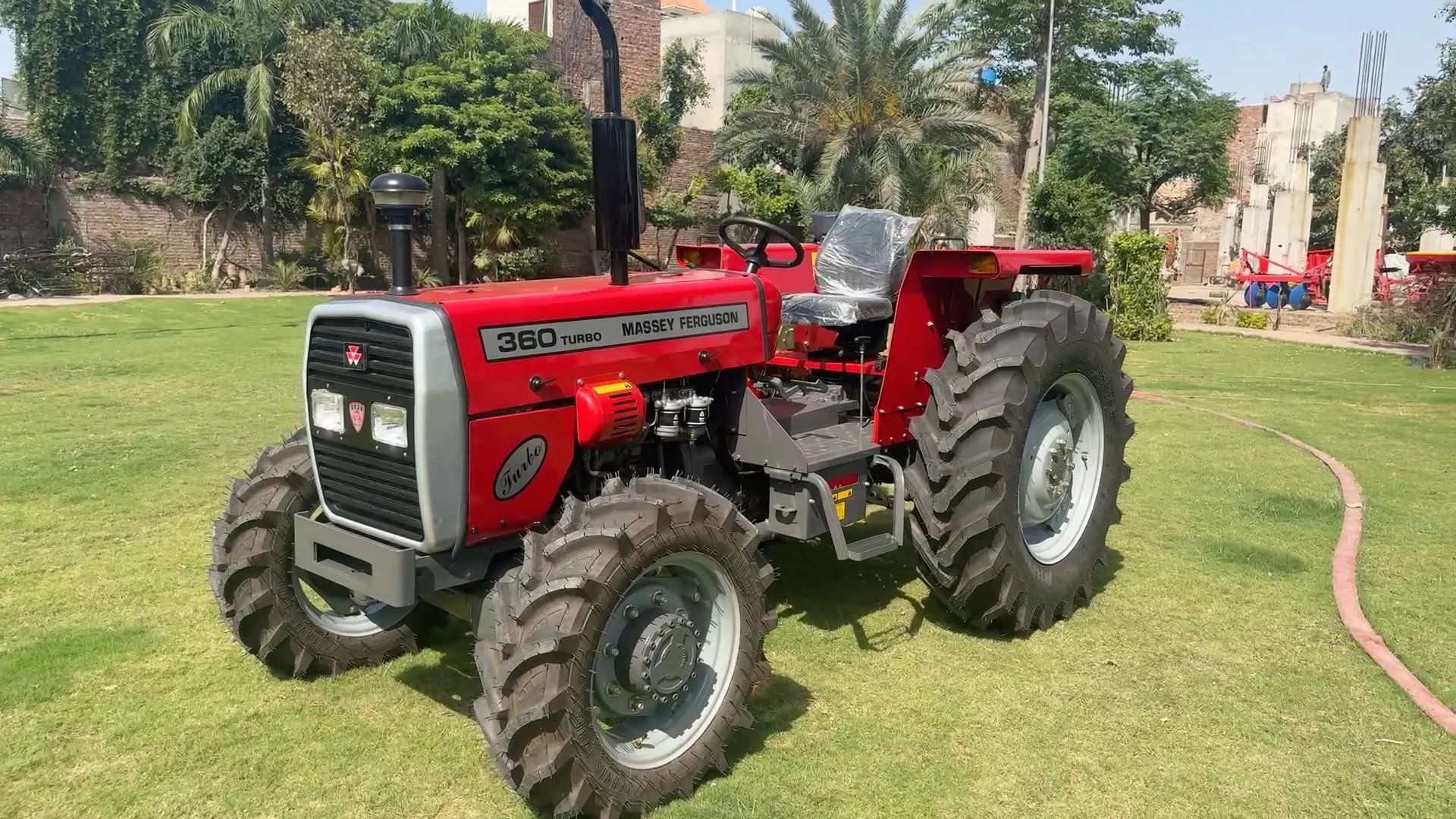 Red Massey Ferguson MF 360 tractor shown from the front left on a lawn